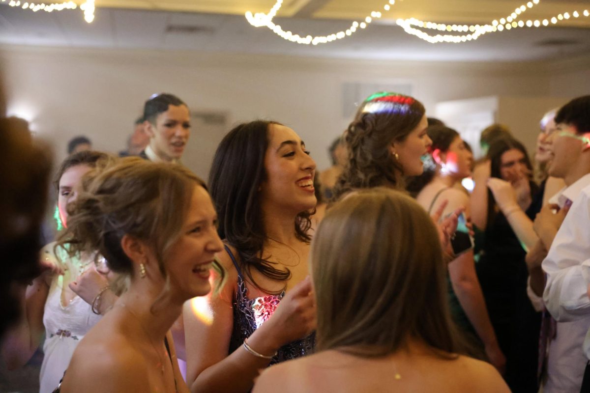 Tessa Aprea (left) and Ellora Kirbat (right) dance through the crowds at CHS prom. Both Kirbat and Aprea are juniors and this was their first time attending the annual dance. "It was really fun," Kirbat said, "it was one of those surreal movie moments where you get to hang out get ready and do all the things you grow up watching." 