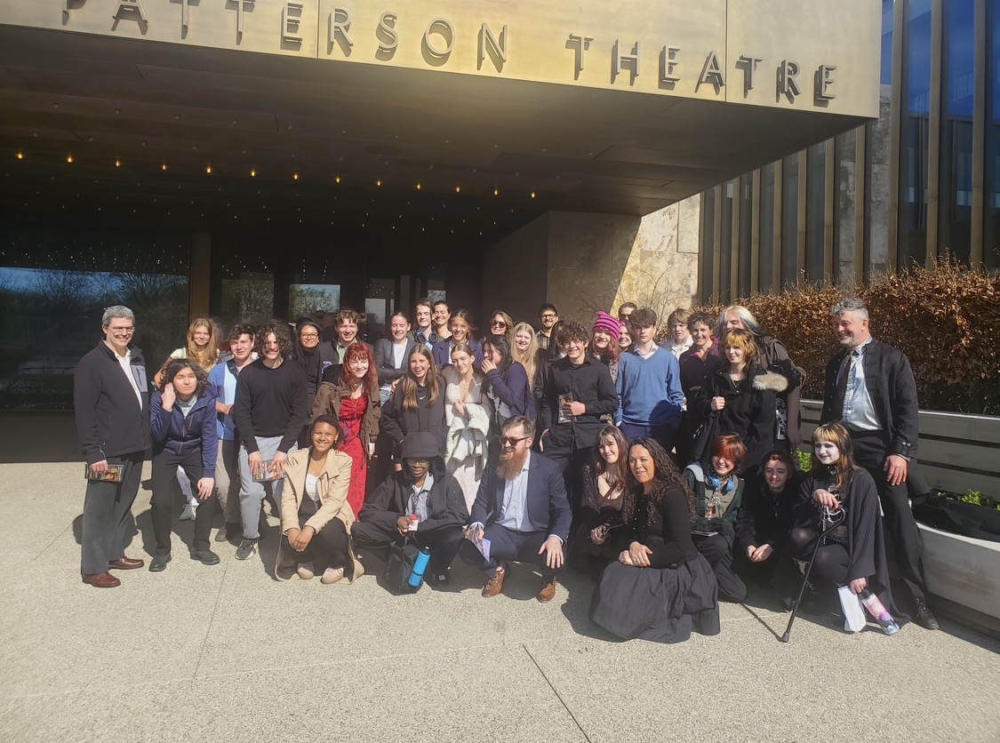 Shakespeare students stand in front of the Tom Patterson Theatre after seeing a performance of A Midsummer Night's Dream.