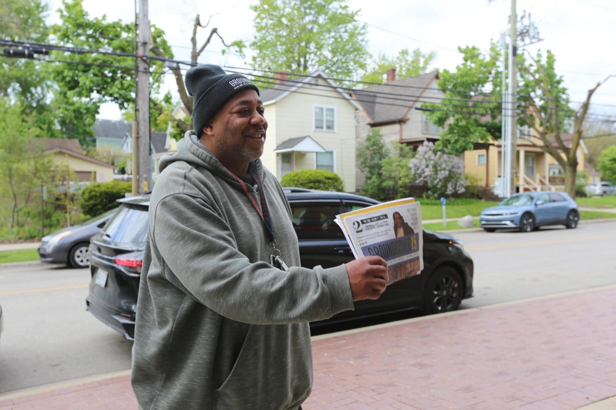 Mike Jones sells "Groundcover News" newspapers outside of the Ann Arbor YMCA.