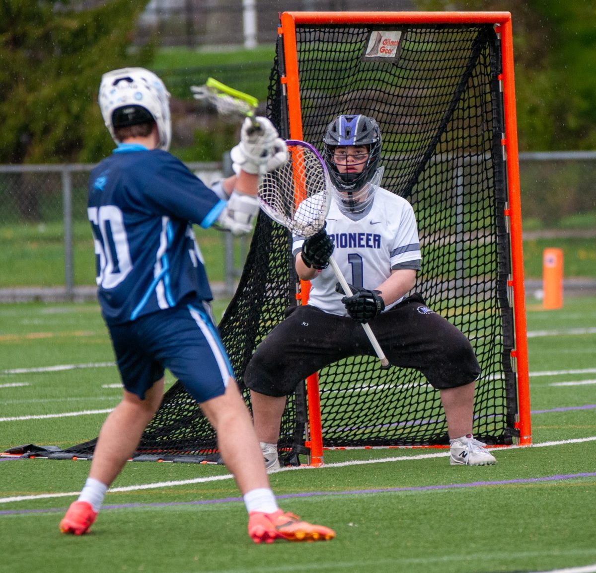 Isaac Meadow saves a shot on goal in the junior varsity game earlier in the day. He played in both games and felt that he played solidly. "I played all right," Meadow said. "Obviously, some things went in, but I stopped some others. It could have been worse."
