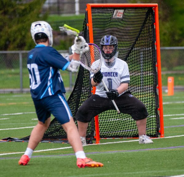 Isaac Meadow saves a shot on goal in the junior varsity game earlier in the day. He played in both games and felt that he played solidly. "I played all right," Meadow said. "Obviously, some things went in, but I stopped some others. It could have been worse."
