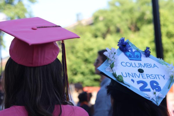 Clara Bailey (left) and Kaylee Gadapalli show off their personalized caps they chose to rock at graduation. Rather than wearing the traditional balck uniform, Bailey chose to rock a vibrant pink color. "We get the option to choose," Bailey said. "So I decided why not!"